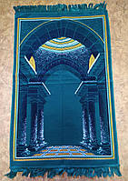 Молитвенный коврик (намазлык), темно-бирюзового цвета с рисунком синего оттенка.