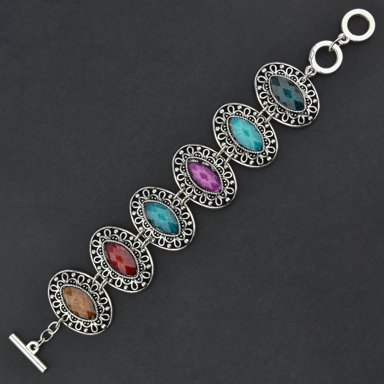 Браслет жіночий сріблястого кольору з різнобарвними камінчиками застібка тогл довжина 22 см ширина 30 мм - фото 1 - id-p1752674466