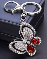 Брелок на ключи или сумку серебристый металл крупная бабочка в камнях камни белые и красные