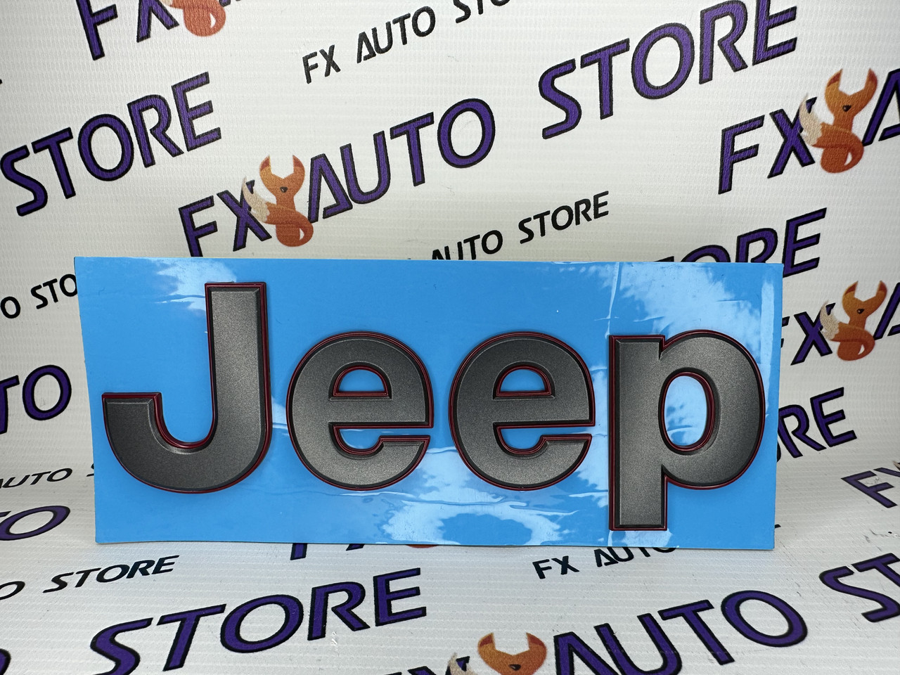 Емблема Jeep 183 х 58 мм графітова з червоним кантом на капот або кришку багажника, на двосторонньому скотчі