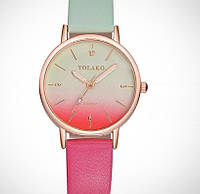 Жіночий градієнтний годинник у м'ятно-рожевому кольорі.