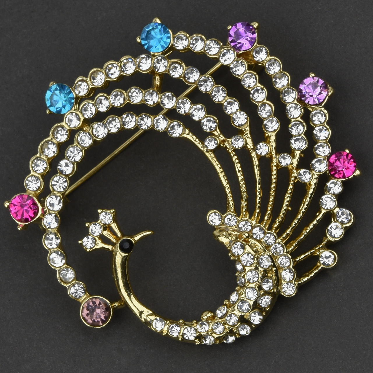 Брошка металева на золотистій основі павич із білими та різнобарвними кристалами розмір 50х50 мм