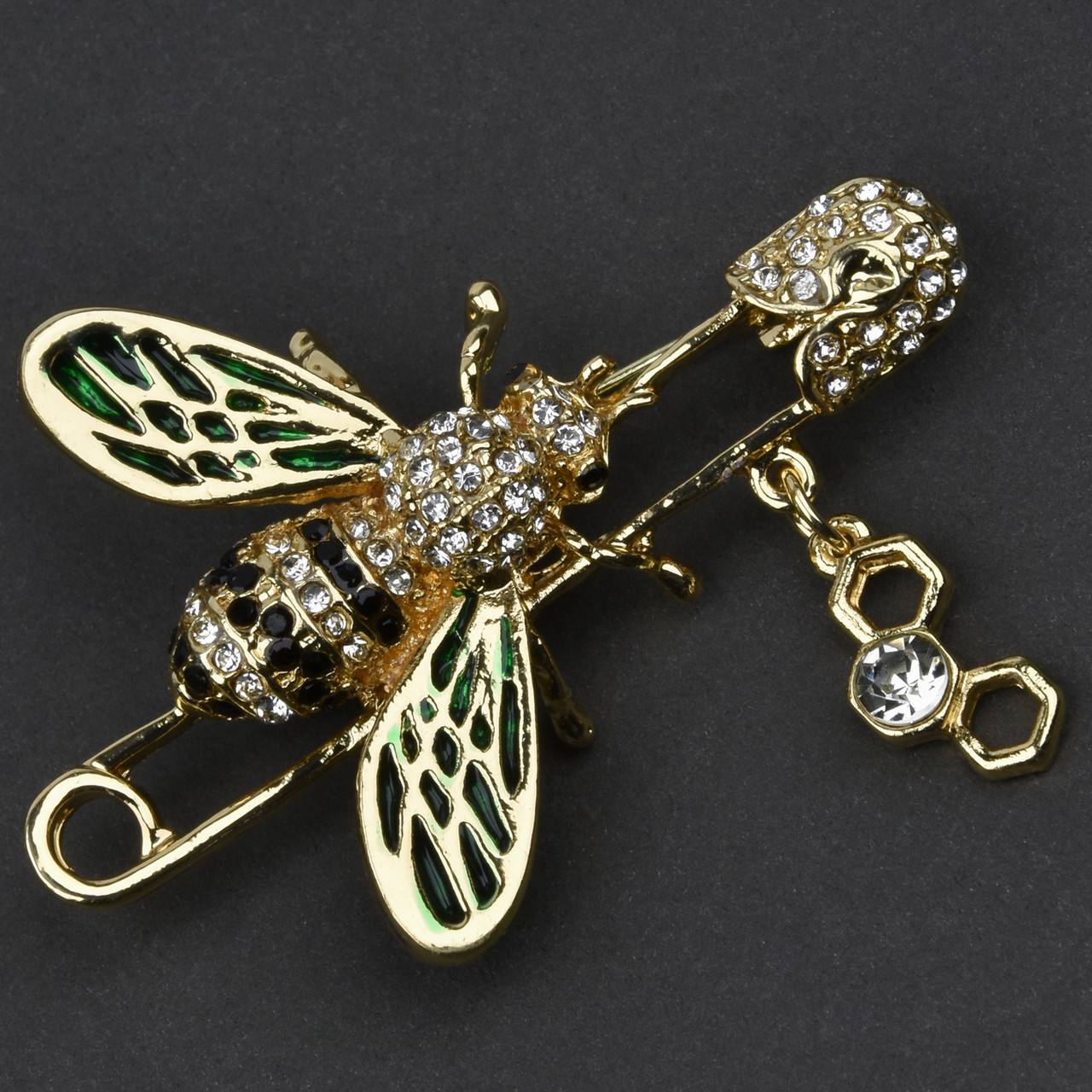 Брошка-бавка металева на золотистій основі бджола з чорними та білими стразами стільники розмір 50х35 мм