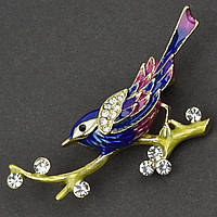 Брошка металева на золотистій основі пташка на гілочці зі стразами покрита кольоровою емаллю розмір 30х50 мм