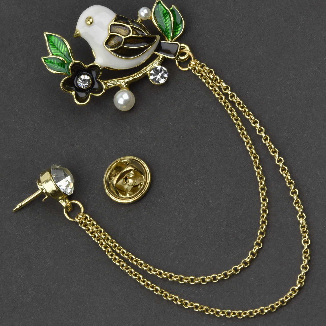 Брошка гвоздик металева на золотистій основі пташка з ланцюжком покрита кольоровою емаллю розмір 35х30 мм