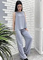 Літній жіночий брючний костюм вільного крою зі штанами палацо