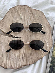 Жіночі сонцезахисні окуляри овальні. Чорні в золотій оправі