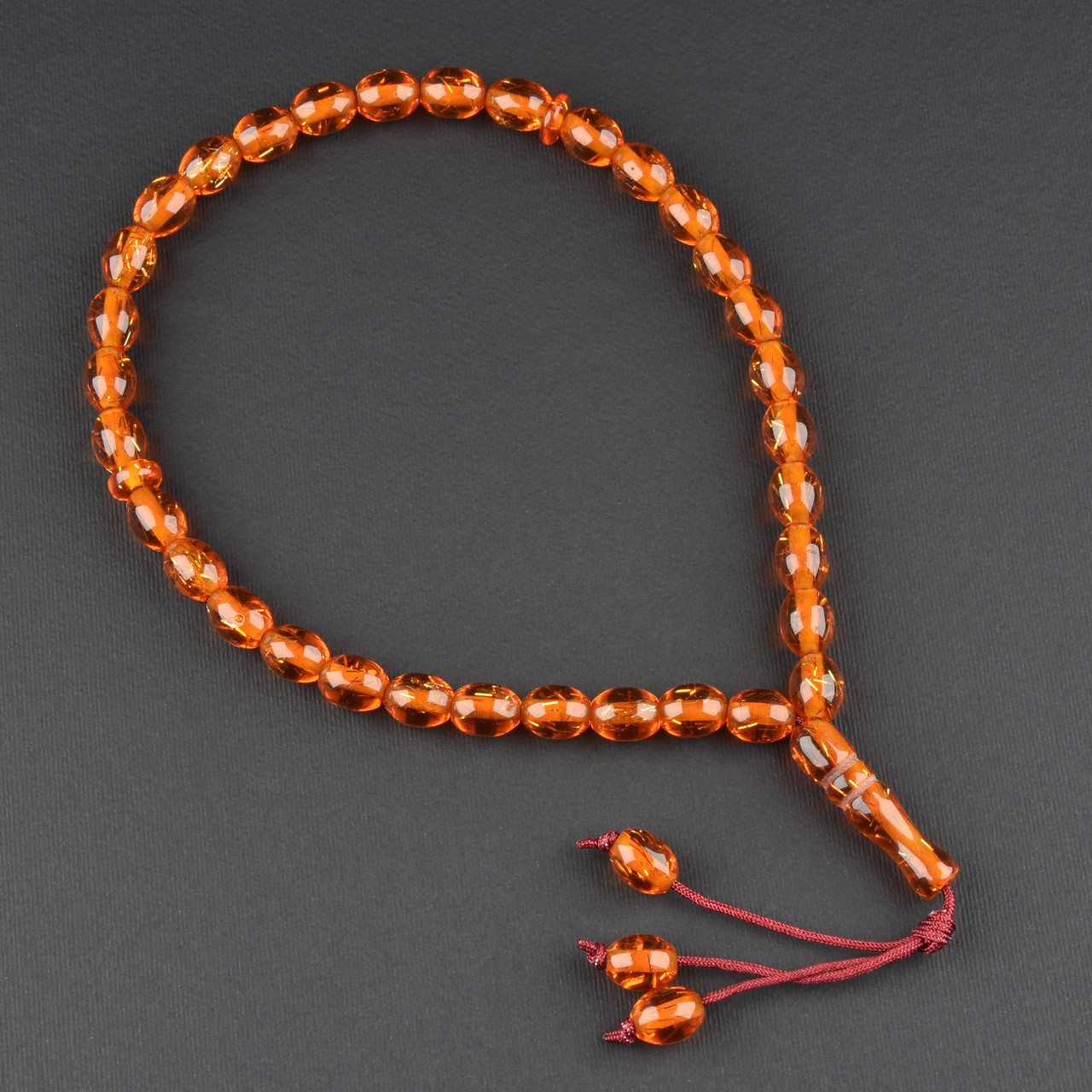 Чітки пластикові з темно жовтогарячими намистинами з блискіточками та висувкою кількість намистин 33 штуки довжина 70 см - фото 1 - id-p1904431180