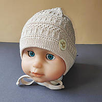 Демісезонна в'язана дитяча шапочка для новонароджених розмір 36-38 на трикотажній підкладці колір бежевий