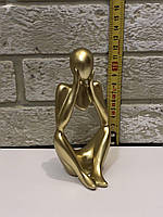 Золота статуетка у вигляді абстрактної людини