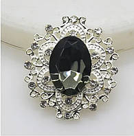 Камінь в сріблястій ажурній оправі 24*26 мм сірий