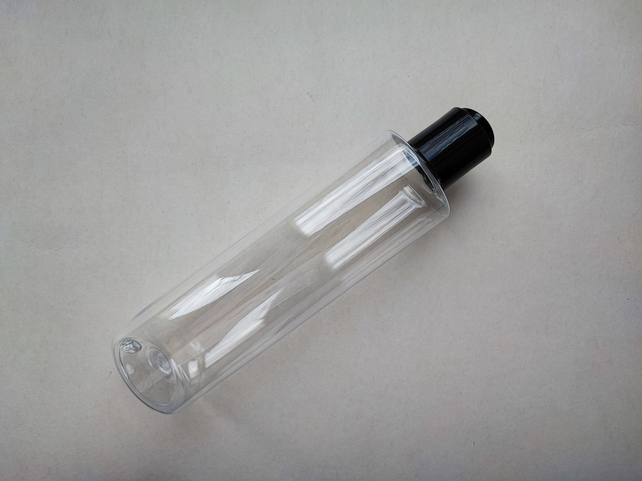 250 мл ПЕТ флакон Циліндр прозорий з кришкою чорною диск-топ 24/410, закруткою пластиковою, пластмасовий