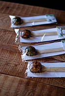 Натуральний трав'яний чай з пелюстками квітів у ложці