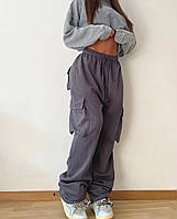 Женские стильные штаны карго оверсайз с накладными карманами и затяжками снизу