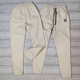 Жіночі утеплені вельветові штани джогери на гумці в молочному кольорі