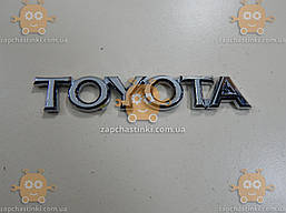 Емблема TOYOTA (напис) на двосторонньому скотчі (Габарити: 105х18мм) 17453