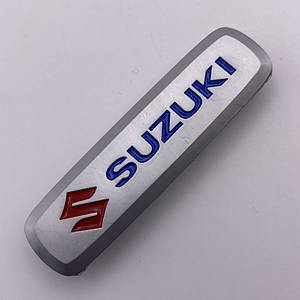 Шильдик на автокилимок сузуки Suzuki