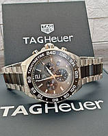 Часы: Tag Heuer.