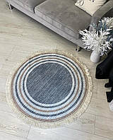 Безворсовий сіро - коричневий круглий килим на прогумованній основі. Туреччина.