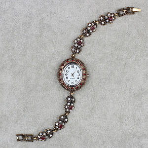 Женские часы наручные овальные кварцевые бижутерный сплав металл в золотистом цвете с рубиновыми камнями