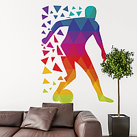 Виниловая интерьерная наклейка декор на стену и обои для мальчика "Футболист ведет мяч. Цветные треугольники"