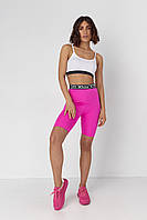 Жіночий костюм із велосипедними шортами та топом