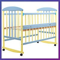 Детская кроватка деревянная из ольхи Наталка ОЖБО на колесах откидной бок желто-голубой