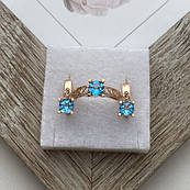 Комплект золотий каблучка та сережки з блакитними круглими топазами 6.59