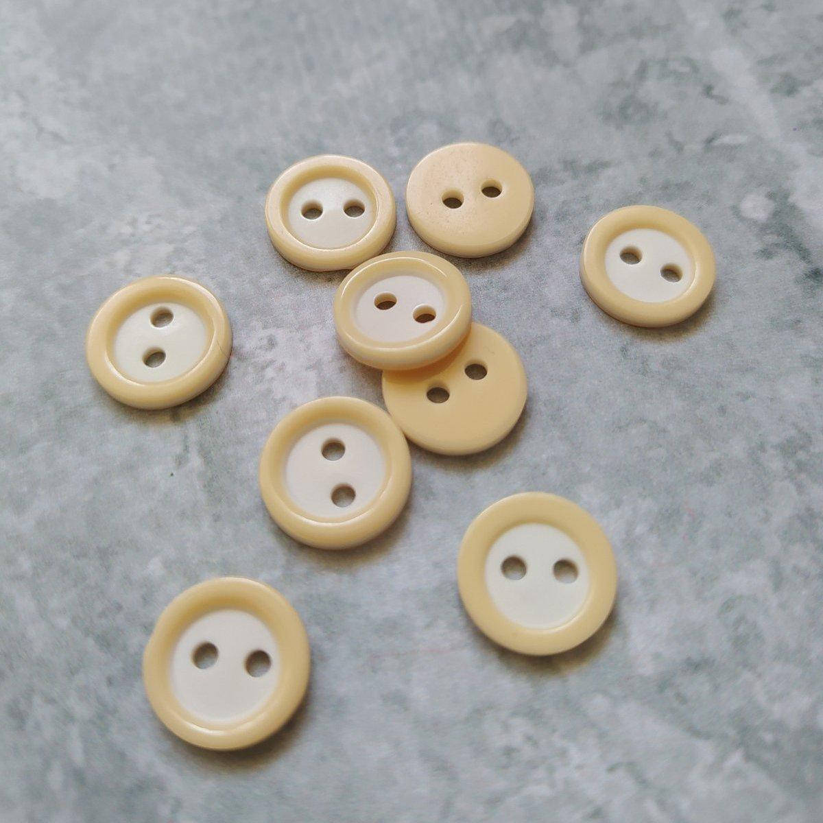 

Пуговичка пластикова з обідком 11 мм (молочна)