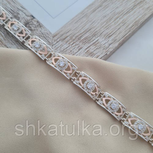 Срібний браслет із золотими вставками та білими цирконами різного розміру