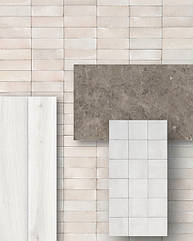 Підлога пропонується в білій версії керамограніту OLTRE з ефектом дерева, на дві стіни - GRANDE STONE LOOK у варіанті GRIS DU GENT в обробці CROGIOLO RICE.