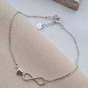 Срібний браслет з круглою підвіскою сердечком та знаком нескінченності