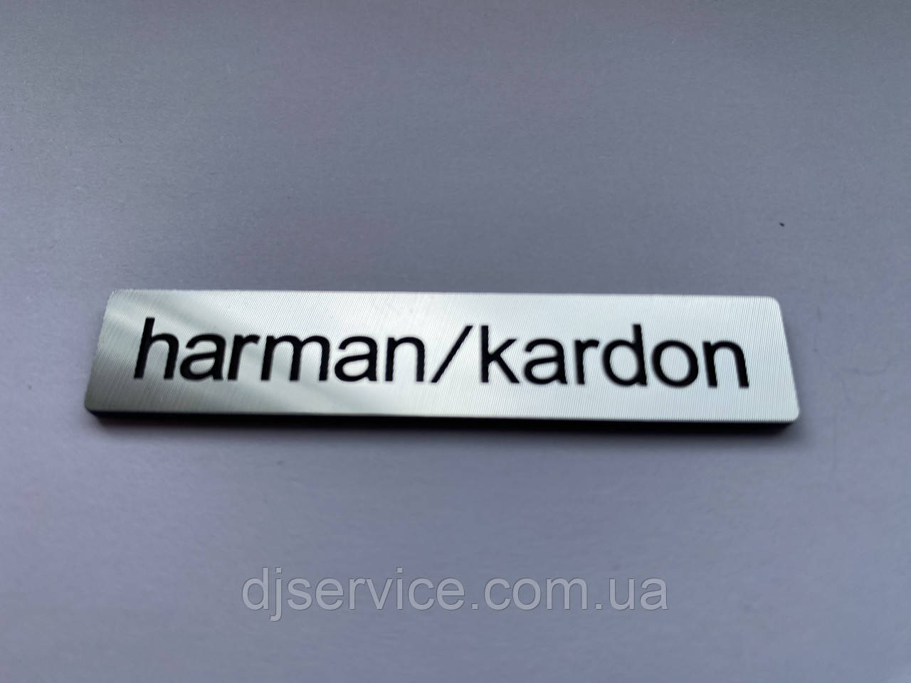 Шильдик, наклейка, логотип 61.5x12mm (metall) на сітку колонки HARMAN/KARDON