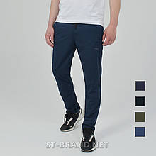 46-56. Якісні та зносостійкі чоловічі спортивні штани із трикотажу лакости - темно-сині