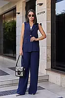 Діловий жіночий брючний костюм зі штанів з високою посадкою та жилет на гудзиках.