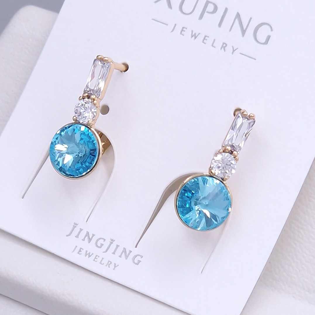 Сережки XР. Позолота 18К. Камені: Swarovski блакитного кольору та циркон. Довжина: 20 мм. Ширина: 8 мм.