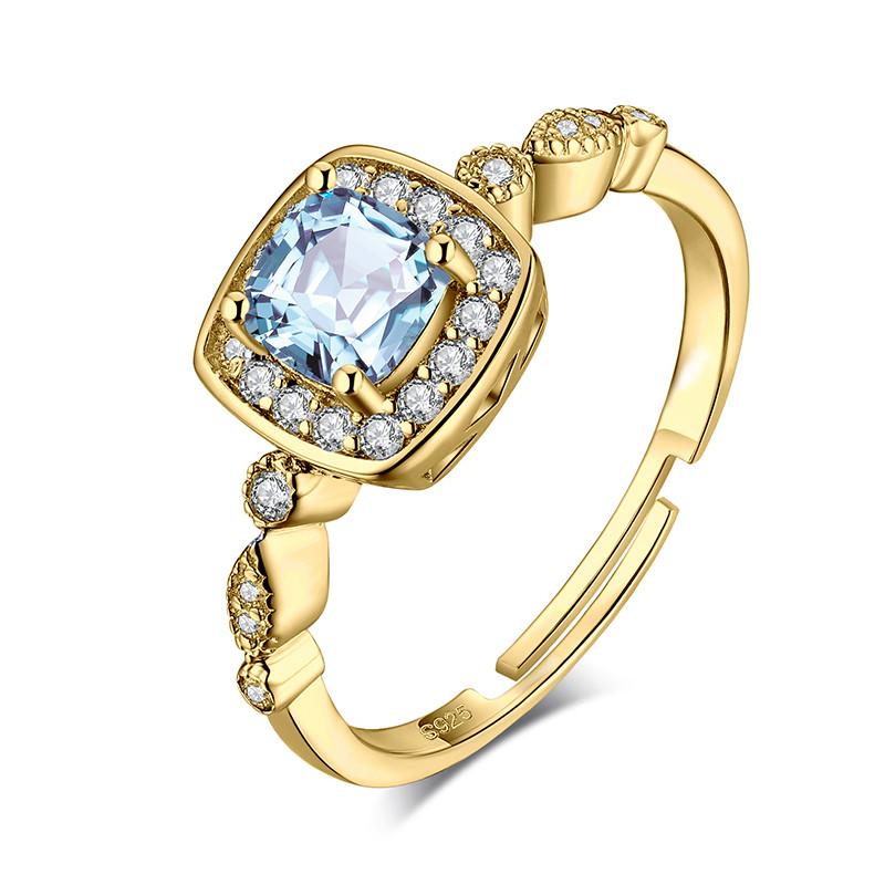 Срібна каблучка з блакитним топазом з позолотою