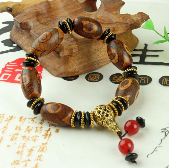 Браслет шість коричневих триочних ДЗД з пензликом