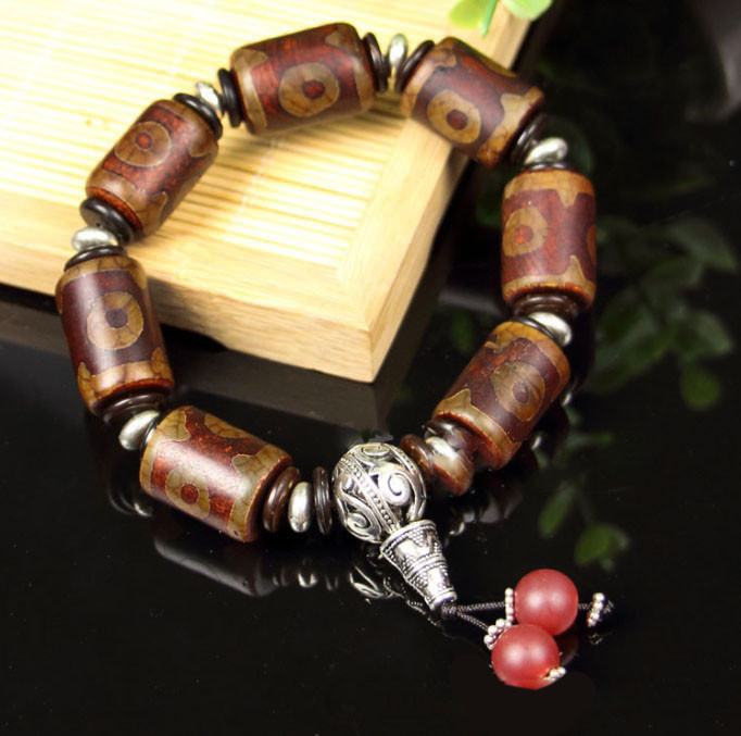 Браслет сім коричневих триочних ДЗ з пензликом