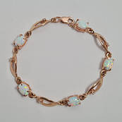 Браслет золотий на руку з білими овальними опалами та фіанітами