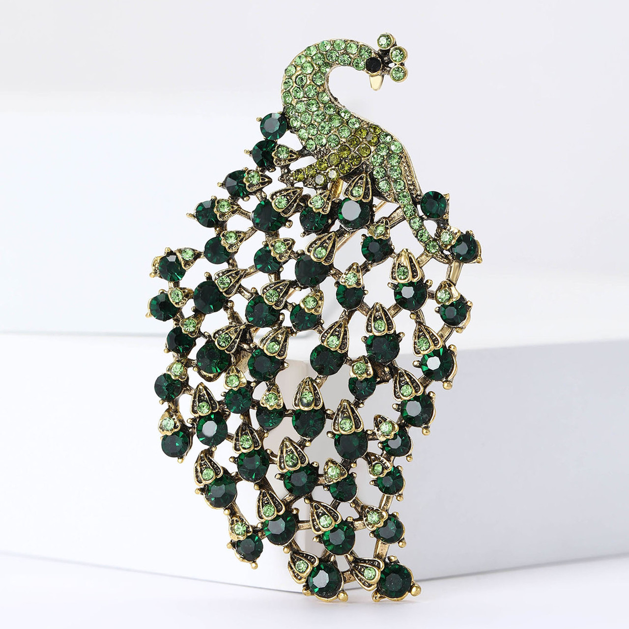 Брошка металева золотиста павич із смарагдовими кристалами розмір виробу 75х45 мм