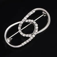 Брошка-бавка металева на сріблястій основі з білими стразами розмір виробу 40х20 мм