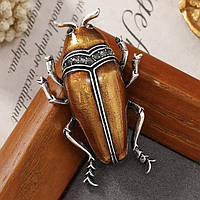 Брошка металева на сріблястій основі жук із чорними кристалами покрита кольоровою емаллю розмір 50х30 мм