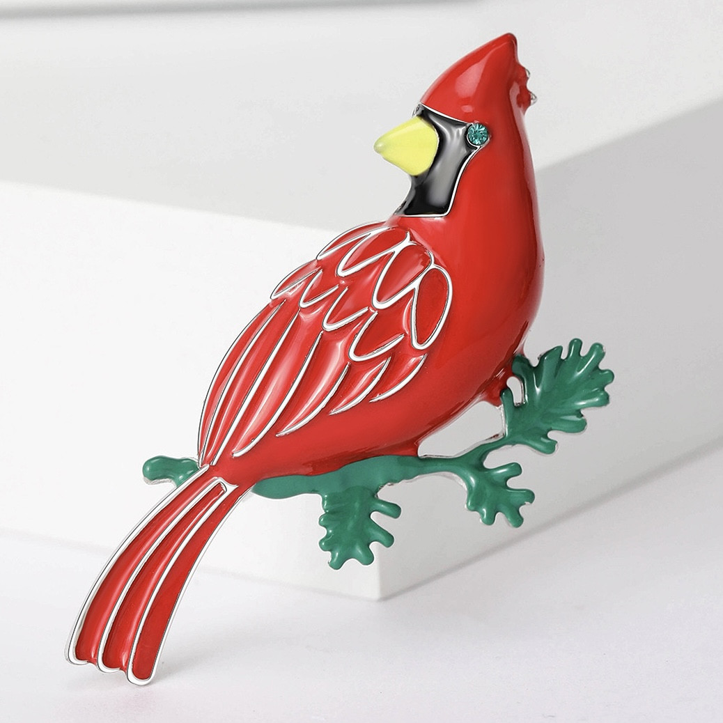 Брошка металева на сріблястій основі червона пташка на гілочці покрита кольоровою емаллю розмір 55х40 мм