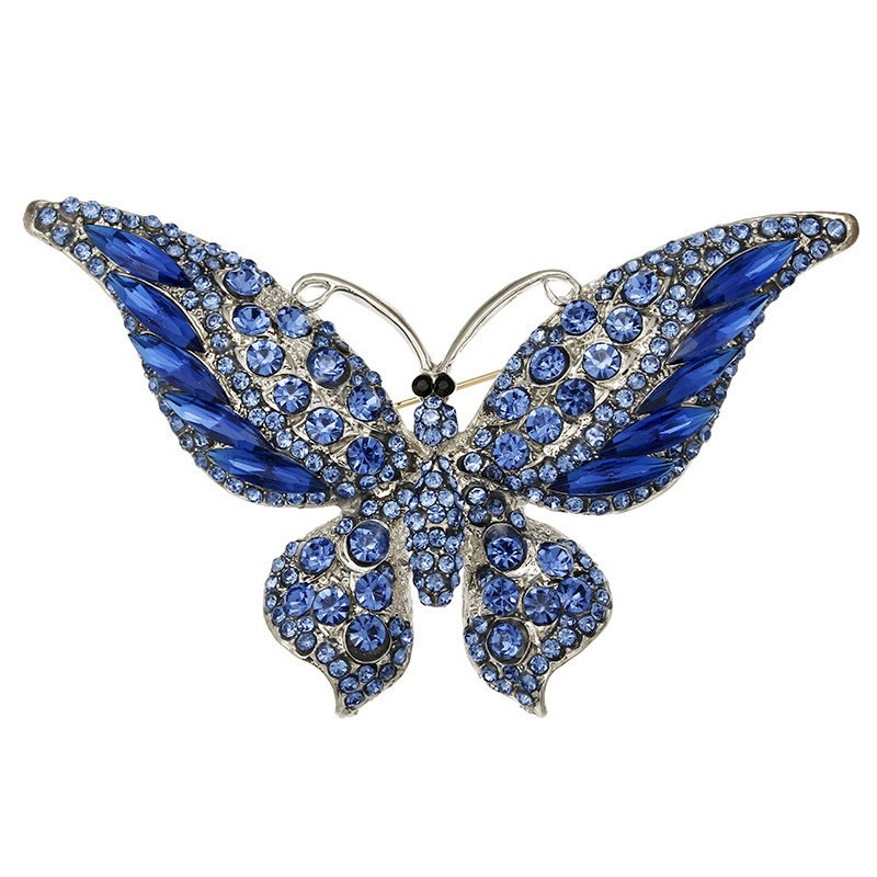 Брошка на сріблястій основі великий метелик із блакитними стразами, що переливаються, розмір 60х85 мм