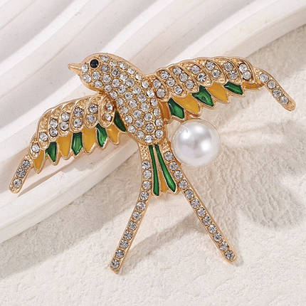 Брошка металева на золотистій основі ластівка з білими стразами покрита кольоровою емаллю розмір 60х55 мм, фото 1