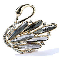 Брошка металева на бронзовій основі лебідь з білими та сірими кристалами розмір 55х50 мм