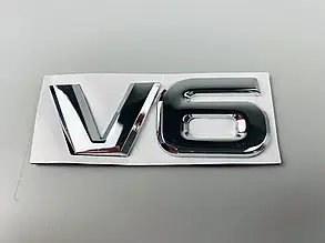 Декоративна металева наклейка, глянсовий срібний колір  «V6», 90 мм х 32 мм х 4 мм DTL-2559