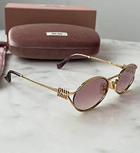 Жіночі круглі жовтогарячі сонцезахисні окуляри Miu Miu MU 54ZS 5AK40D із золотим логотипом Міу Міу