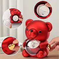 Скринька-ведмідь, що обертається, з трояндою в колбі